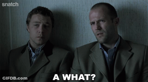 Two Men In Suits Are Sitting Next To Each Other And One Of Them Is Asking A What GIF