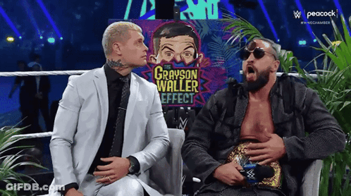 Two Men In Suits Are Sitting Next To Each Other On A Couch And Talking . GIF
