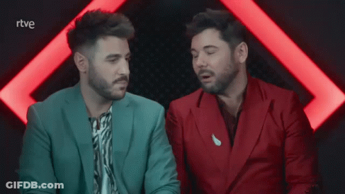 Two Men In Suits Are Sitting Next To Each Other With The Letters Rtve Visible GIF
