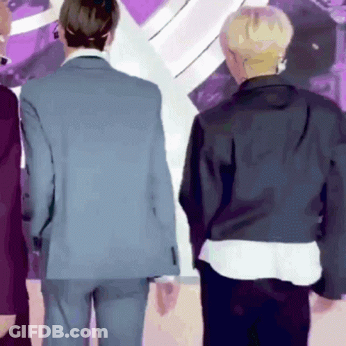 Two Men In Suits Are Standing Next To Each Other GIF