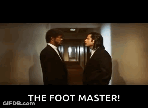 Two Men In Suits Are Standing Next To Each Other In A Hallway And One Of Them Is Saying `` The Foot Master '' . GIF