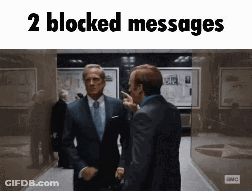 Two Men In Suits Are Standing Next To Each Other In A Hallway With The Words " 2 Blocked Messages " Above Them . GIF