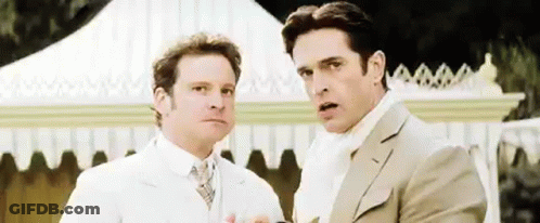 Two Men In Suits Are Standing Next To Each Other In Front Of A White Tent . GIF