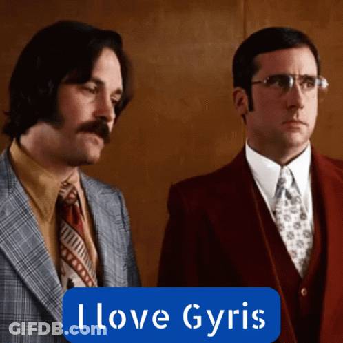 Two Men In Suits Are Standing Next To Each Other With A Blue Sign That Says I Love Gyris GIF