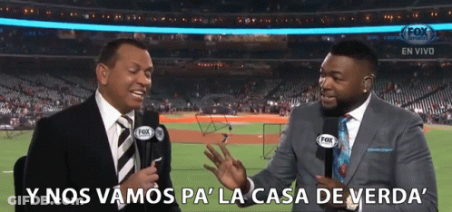 Two Men In Suits Are Talking To Each Other In Front Of A Fox Stadium GIF