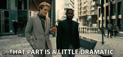 Two Men In Suits Are Walking Down A Street With The Words That Part Is A Little Dramatic Below Them GIF