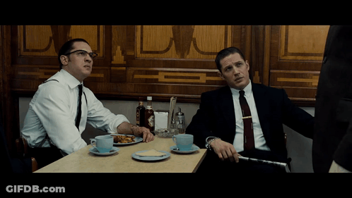 Two Men In Suits At Table With Food And Coffee GIF
