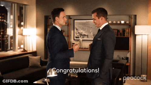 Two Men In Suits Congratulating Each Other With Peacock GIF