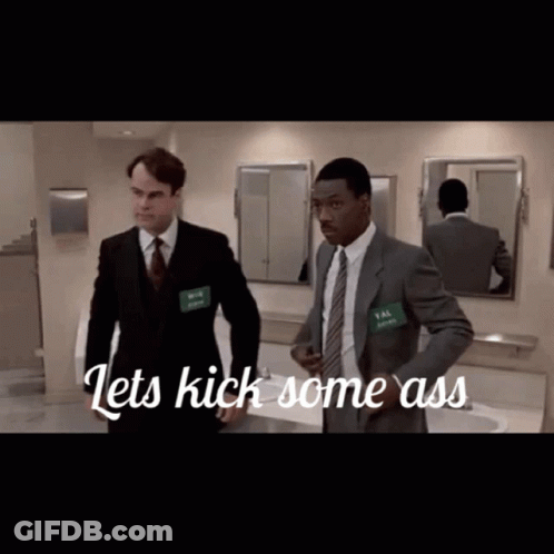 Two Men In Suits In Bathroom Saying Lets Kick Some Ass GIF