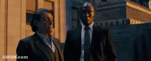 Two Men In Suits In Front Of A & A Building GIF