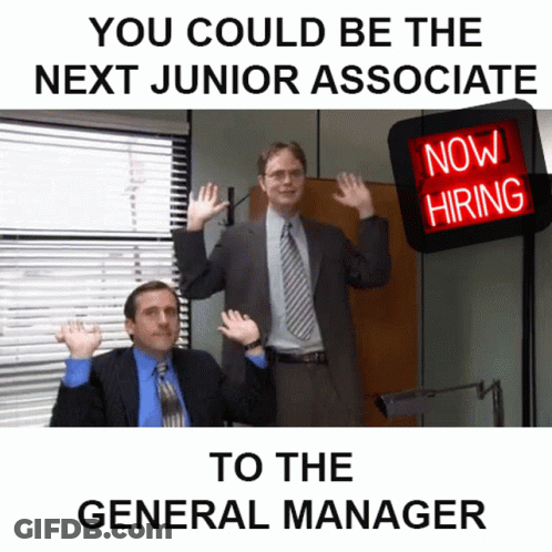 Two Men In Suits In Front Of Now Hiring Sign GIF