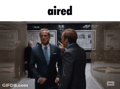 Two Men In Suits In Hallway With Word Aired GIF