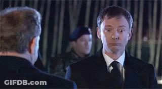 Two Men In Suits Looking At Each Other GIF