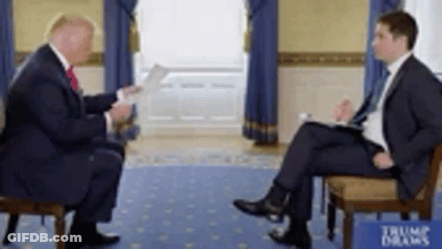 Two Men In Suits Sitting And Talking GIF