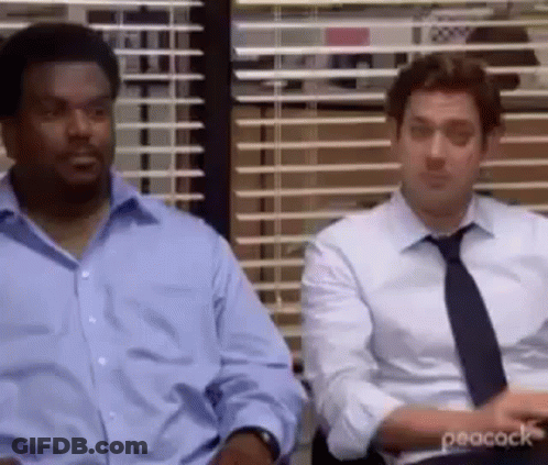 Two Men In Suits Sitting By Office Window GIF