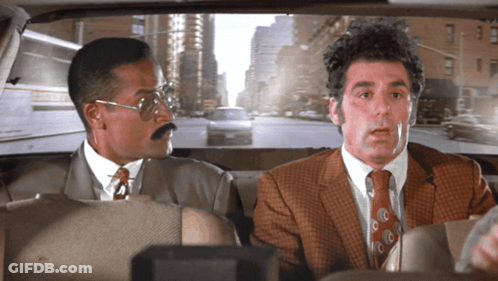 Two Men In Suits Sitting In Car Looking Out Window GIF