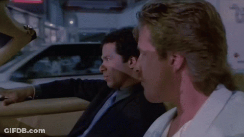 Two Men In Suits Sitting In Car Talking GIF