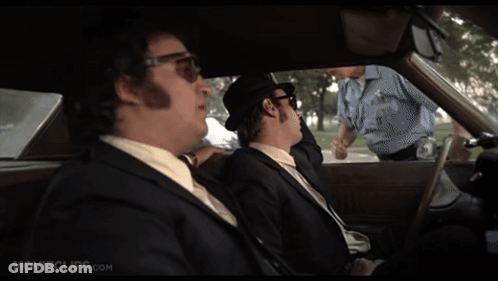 Two Men In Suits Sitting In Car With Movieclips.com GIF