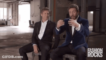 Two Men In Suits Sitting With Fashion Rocks GIF
