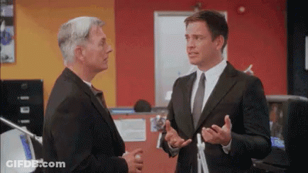 Two Men In Suits Standing GIF