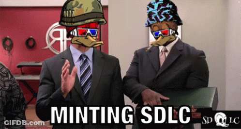 Two Men In Suits Standing Next To Each Other With The Words Minting Sdlc Written On The Bottom GIF
