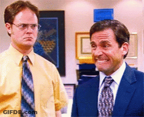 Two Men In Suits Standing Together GIF