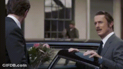Two Men In Suits Standing Together GIF