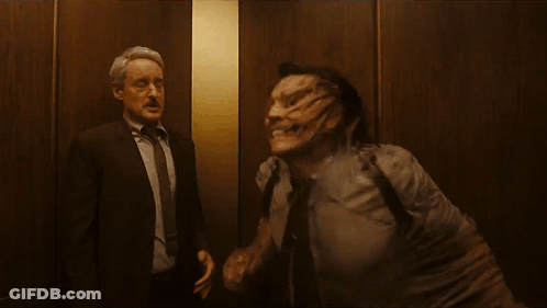 Two Men In Suits Standing Together GIF