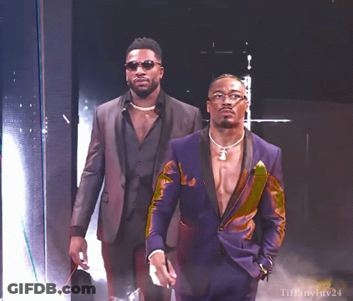 Two Men In Suits Standing Together GIF