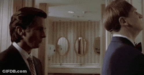 Two Men In Suits Standing Together GIF