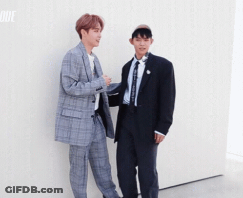 Two Men In Suits Standing Together GIF
