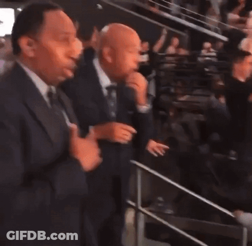 Two Men In Suits Standing Together GIF