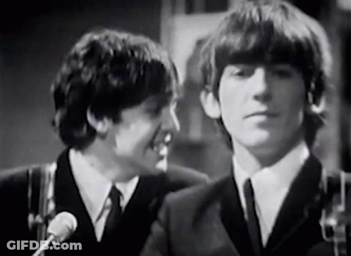 Two Men In Suits Talking Into Microphones GIF