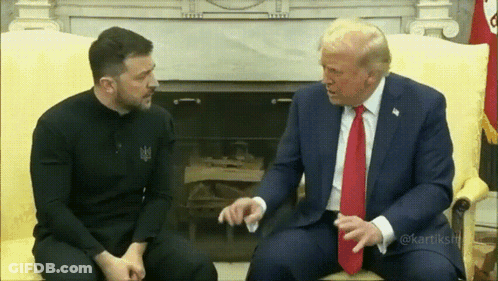 Two Men In Suits Talking On Couch GIF