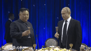 Two Men In Suits Toasting With Champagne GIF