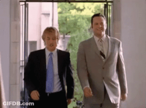 Two Men In Suits Walking In Room GIF