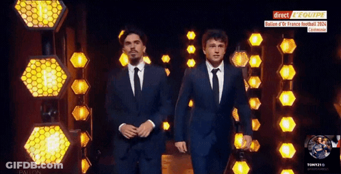 Two Men In Suits Walking Past Direct Reequipe Sign GIF