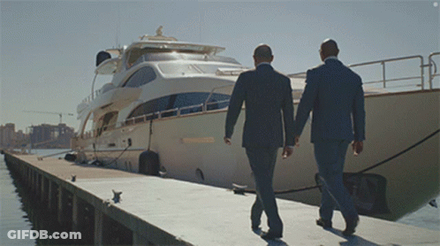 Two Men In Suits Walking Toward Boat Saying Shannon GIF