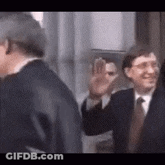 Two Men In Suits Waving GIF