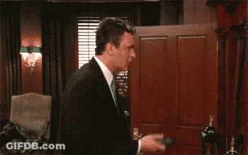 Two Men In Suits With Hands In Air GIF