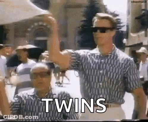 Two Men In Sunglasses Beside Each Other Arms Raised GIF