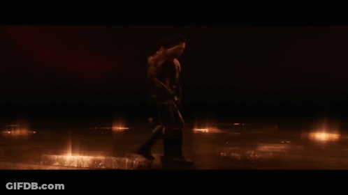 Two Men In Superhero Costumes Standing In Dark GIF