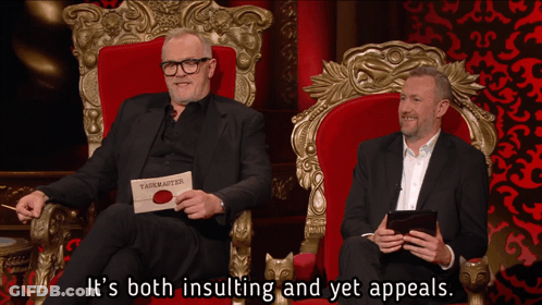 Two Men In Throne One Holding Card Saying Taskmaster GIF