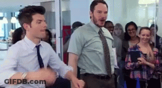Two Men In Ties Are Dancing In Front Of A Crowd Of People . GIF