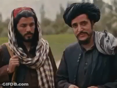 Two Men In Turbans And Scarves Talking GIF