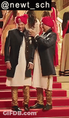 Two Men In Turbans Standing On Stairs GIF