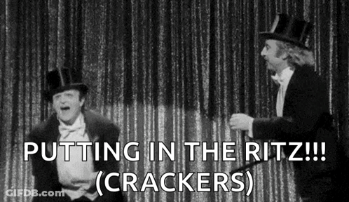 Two Men In Tuxedos And Top Hats On Stage GIF