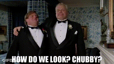 Two Men In Tuxedos Are Standing Next To Each Other And One Of Them Is Asking How Do We Look ? Chubby ? GIF