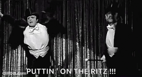Two Men In Tuxedos Dancing On Stage GIF