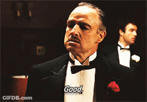 Two Men In Tuxedos Saying Good GIF